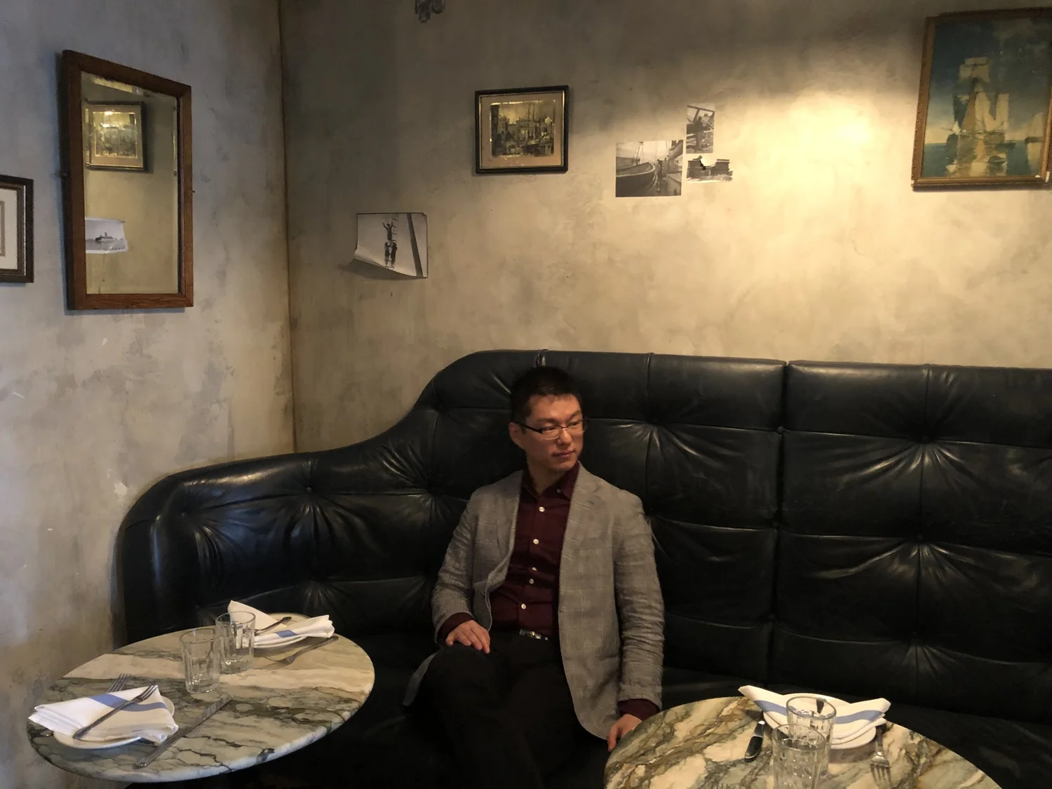 Jae Kim seated in a dimly lit room